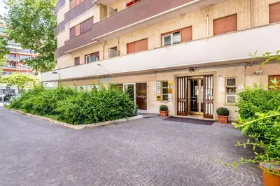a building with a courtyard in front of it at Real Vatican Inn in Rome