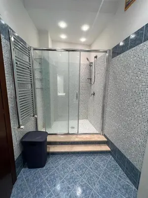 a bathroom with a shower with a glass shower stall at Goiran@4 in Rome