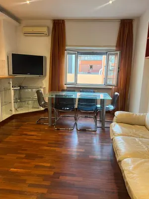 a living room with a glass table and a couch at Goiran@4 in Rome