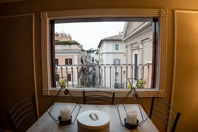 a table with a large window looking out at a city at Sweet Roof Rhome in Rome