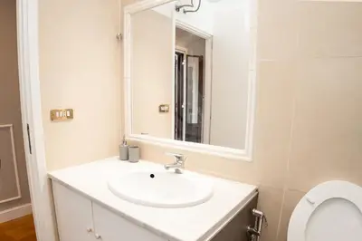 a bathroom with a sink and a mirror at Sweet Roof Rhome in Rome