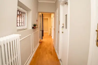 a hallway of a home with white walls and wood floors at Sweet Roof Rhome in Rome