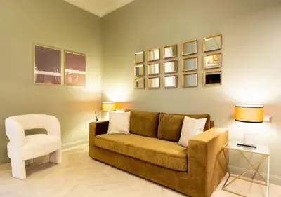 a living room with a couch and a chair at MAISON CAIO 7 in Rome