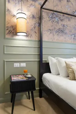 a bedroom with a bed and a side table with a lamp at MAISON CAIO 7 in Rome