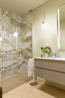a bathroom with a shower with a sink and a mirror at MAISON CAIO 7 in Rome