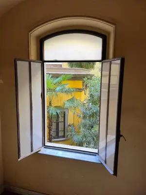an open window with a view of a building at MAISON CAIO 7 in Rome