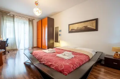 a bedroom with a large bed with two towels on it at Rialto Apartment Vatican Museums in Rome