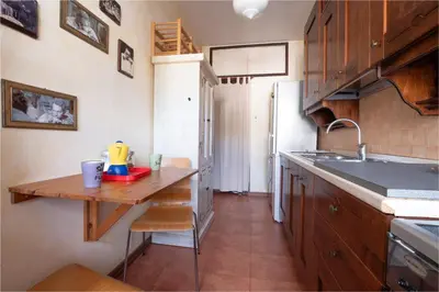 a kitchen with a wooden counter and a sink at Rialto Apartment Vatican Museums in Rome