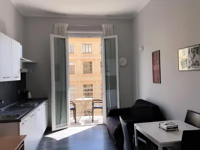 a room with a kitchen and a living room at The Manzoni in Rome