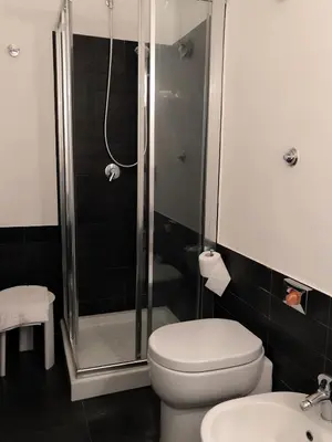 a bathroom with a shower and a toilet and a sink at The Manzoni in Rome