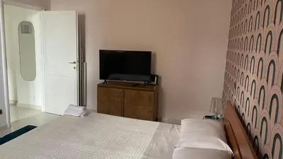 a bedroom with a bed and a flat screen tv at Good Time Apartment in Rome