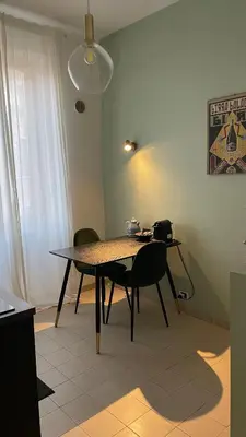 a dining room table and chairs in a room at Good Time Apartment in Rome