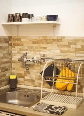a kitchen counter with a sink and a dish rack at 450mt to Basilica S.Pietro in Rome