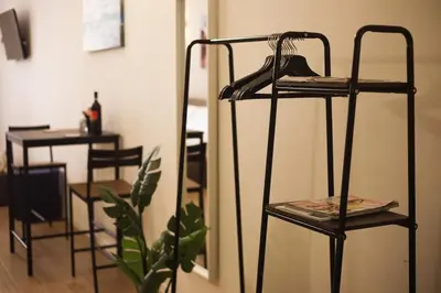 a room with two shelves with a plant and a table at 450mt to Basilica S.Pietro in Rome