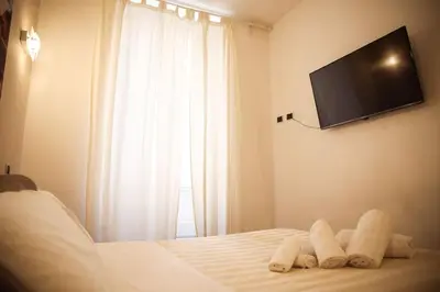 a hotel room with a bed with towels on it at 450mt to Basilica S.Pietro in Rome