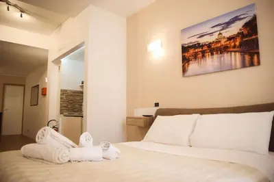 a bedroom with a bed with towels on it at 450mt to Basilica S.Pietro in Rome