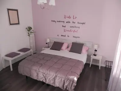 a bedroom with a bed with a quote on the wall at Vica Pota in Rome