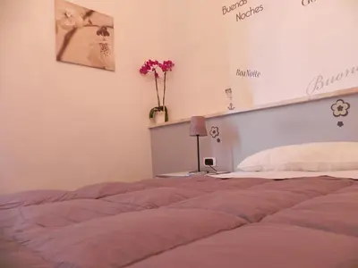a bedroom with a bed and a vase of flowers at Vica Pota in Rome