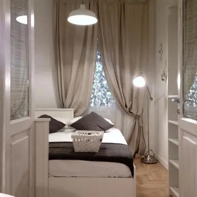 a small bedroom with a bed with a window at VATICAN CITY 76 Apartment in Rome