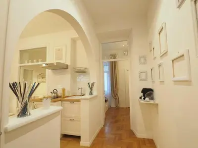 a kitchen with an archway and a sink and a counter at VATICAN CITY 76 Apartment in Rome