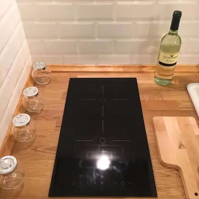 a bottle of wine sitting on a wooden table with a laptop at VATICAN CITY 76 Apartment in Rome