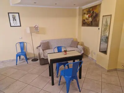 a living room with a couch and a table and chairs at casa alibrandi in Rome