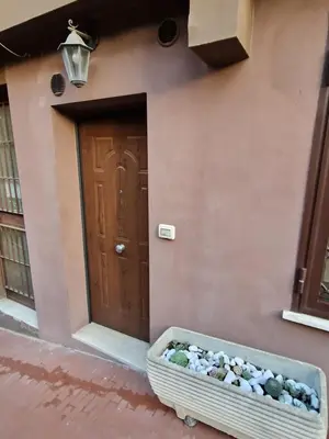 a front door of a house with a basket of rocks at casa alibrandi in Rome