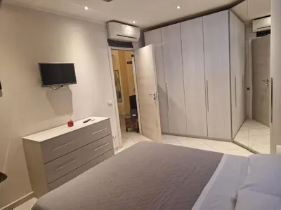 a bedroom with a bed and a tv on the wall at casa alibrandi in Rome