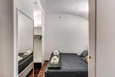 a bedroom with a bed and a mirror at Residenza Caprera in Rome