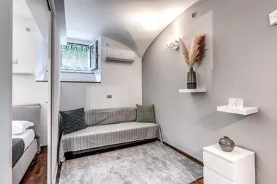 a small room with a couch and a bed at Residenza Caprera in Rome