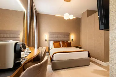 a hotel room with a bed and a desk at Royal Rooms Corso in Rome