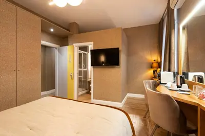 a room with a bed and a table with chairs at Royal Rooms Corso in Rome