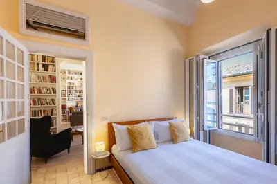 a bedroom with a bed and a large window at Amazing Campo de' Fiori in Rome