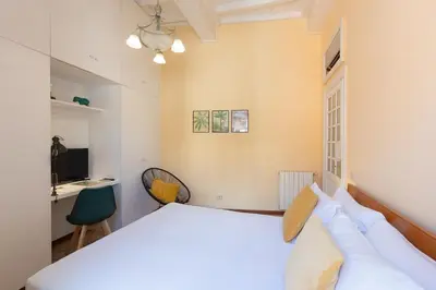 a bedroom with a white bed and a desk at Amazing Campo de' Fiori in Rome