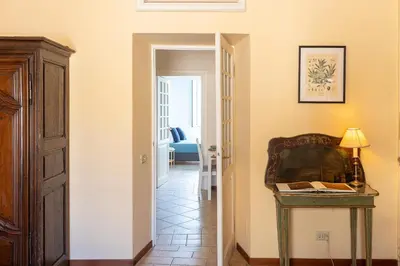 a hallway with a table and a chair in a room at Amazing Campo de' Fiori in Rome