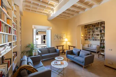 a living room with couches and bookshelves at Amazing Campo de' Fiori in Rome