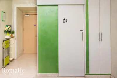 a green and white door in a hallway at Romatic in Rome