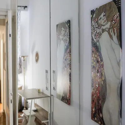 a living room with two paintings on the wall at San Pietro Garden House in Rome