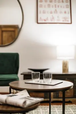 a coffee table with two glasses on top of it at San Pietro Garden House in Rome