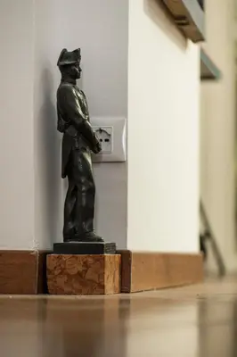 a statue of a man standing in front of a clock at San Pietro Garden House in Rome