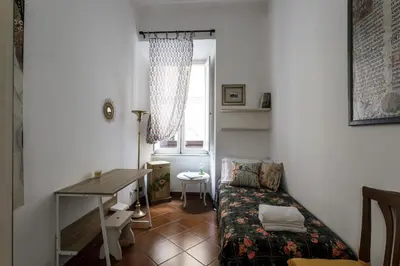 a small room with a desk and a bed at San Pietro Garden House in Rome