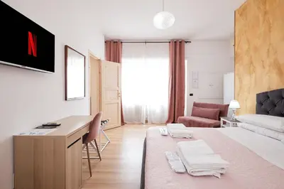 a room with a bed and a desk and a couch at Il Pontefice Luxury in Rome