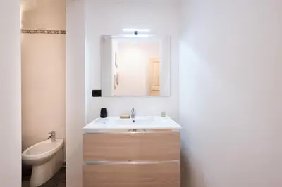 a bathroom with a sink and a toilet and a mirror at Il Pontefice Luxury in Rome