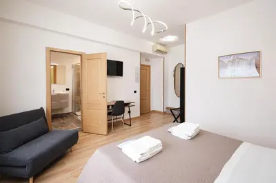 a living room with a bed and a couch at Il Pontefice Luxury in Rome