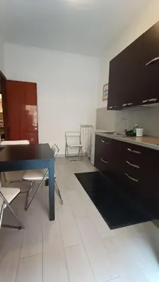 a kitchen with a table and chairs in a room at Casilina One in Rome