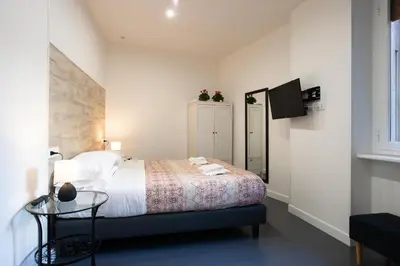 a bedroom with a bed with a table and a tv at St. Peter Boutique Apt in Rome