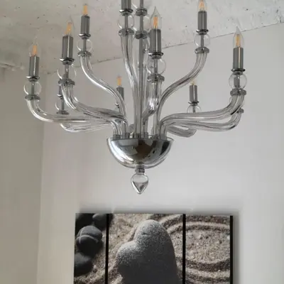 a chandelier hanging from a ceiling with a picture at Panorama suites & flats in Rome