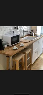 a kitchen with a microwave and a wooden table at Panorama suites & flats in Rome