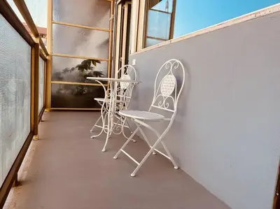 a couple of chairs sitting on a balcony at Luxury apartment Balduina - Casa di Irene in Rome