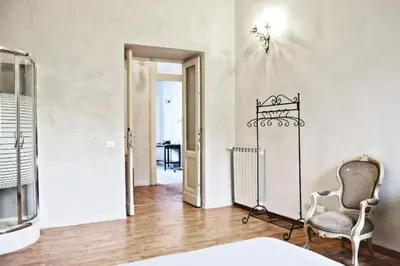 a room with a bed and a chair and a door at Casa Particular Vintage in Rome